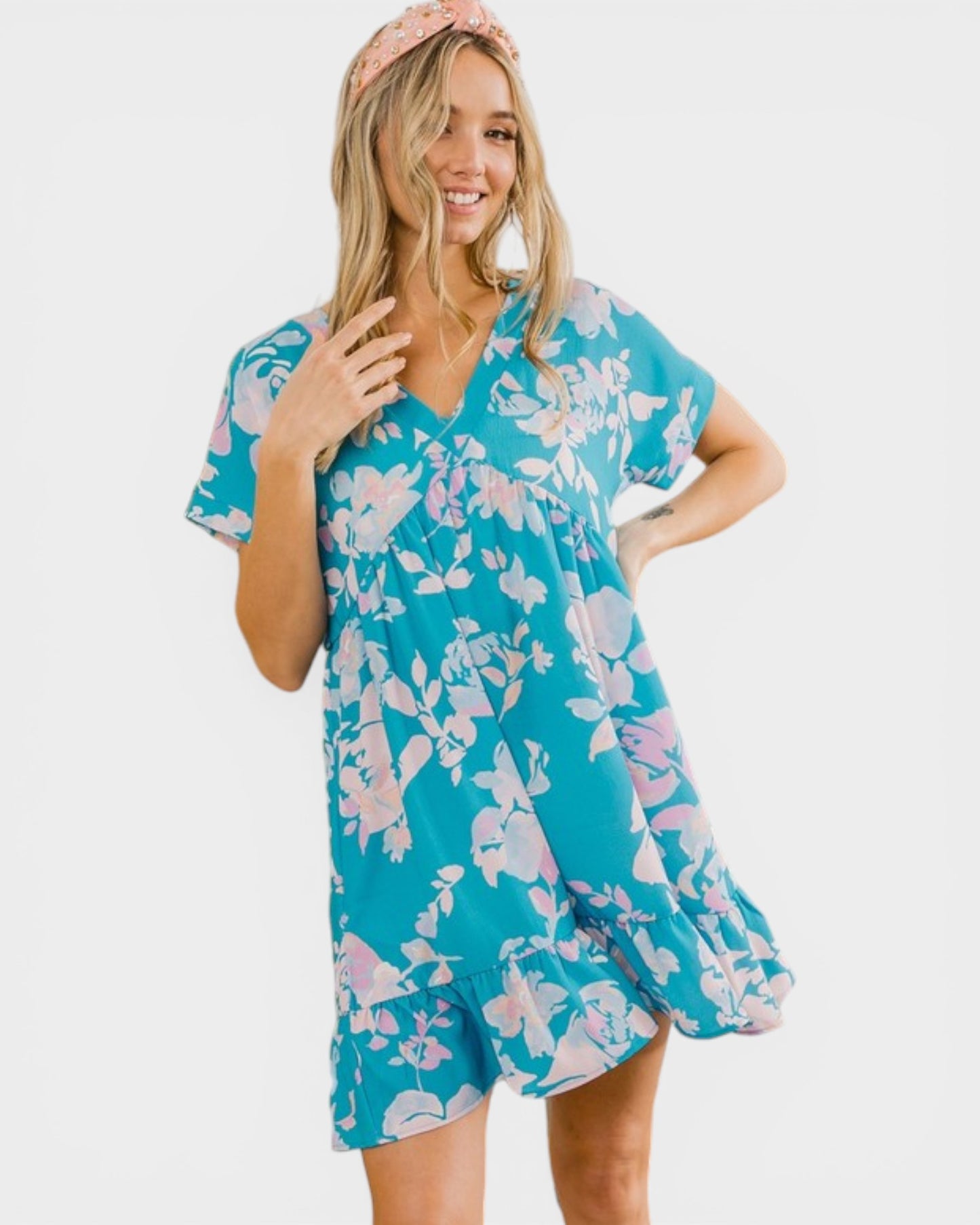 Woman wearing a blue floral dress on a white background