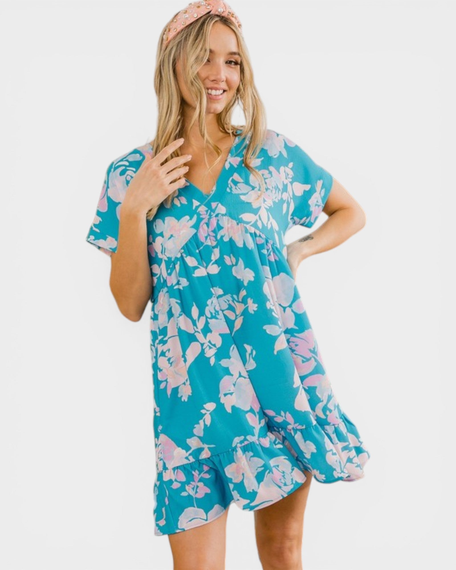 Woman wearing a blue floral dress on a white background