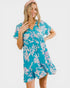 Woman wearing a blue floral dress on a white background