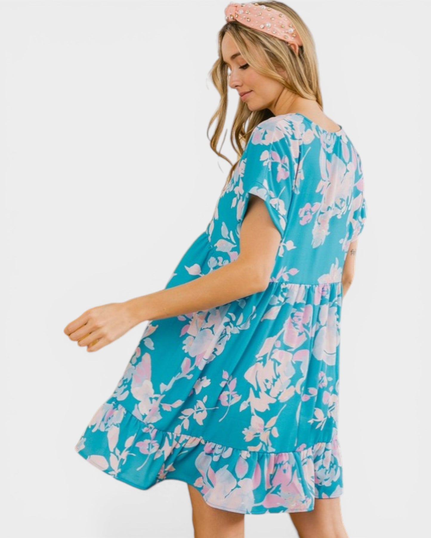 Woman wearing a blue floral dress on a white background