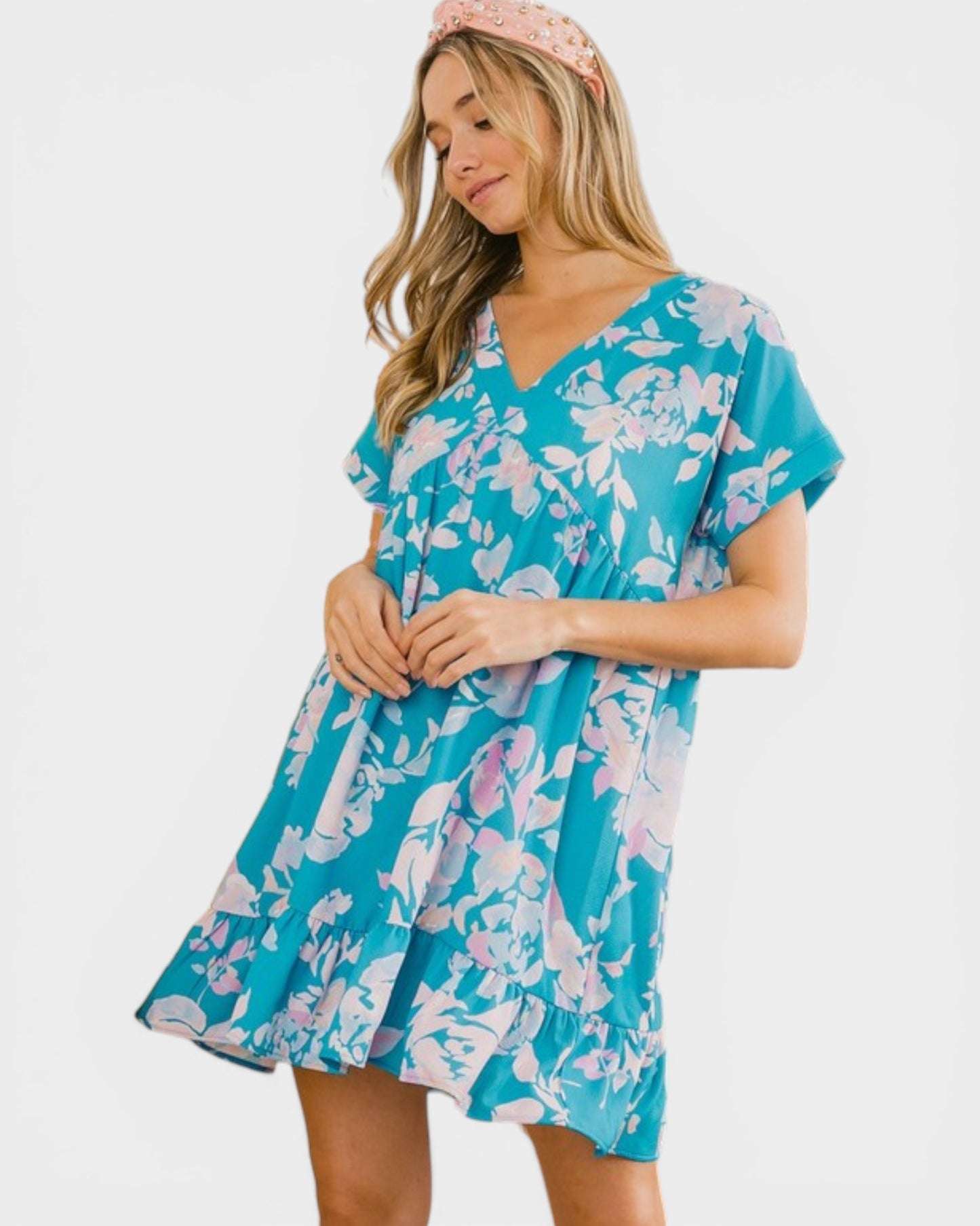 Woman wearing a blue floral dress on a white background