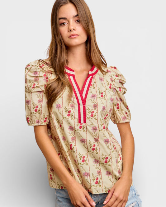 Woman wearing a floral blouse with a plain background