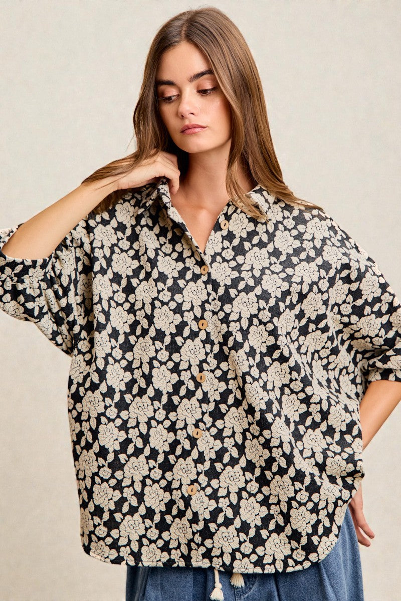 Woman wearing a floral blouse with a neutral background