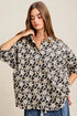 Woman wearing a floral blouse with a neutral background