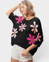 Suéter corto con estampado floral fucsia rosa en negro