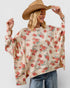 Woman wearing a floral poncho and wide-brimmed hat on a plain background