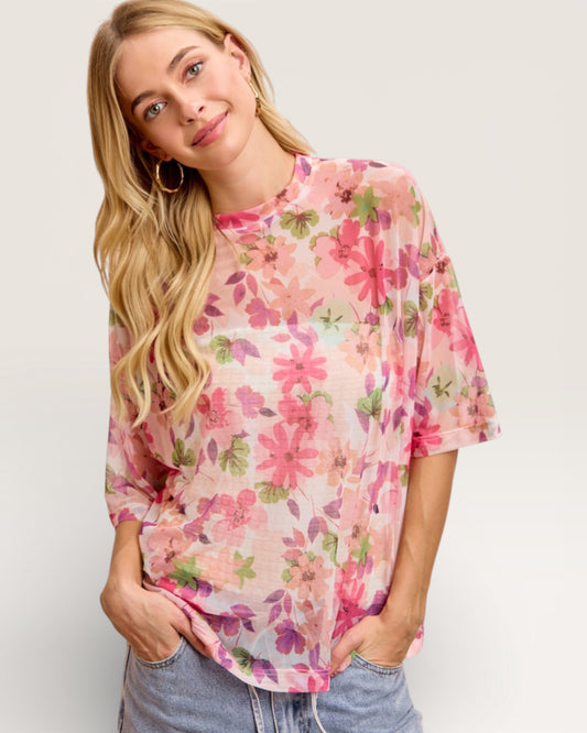 Woman wearing a floral blouse with a plain background