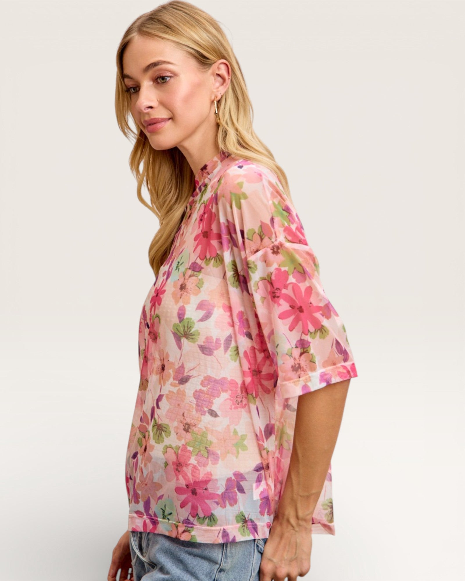 Woman wearing a floral blouse with a plain background