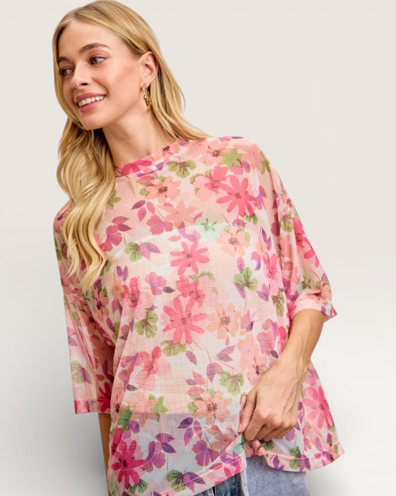 Woman wearing a floral blouse with a plain background