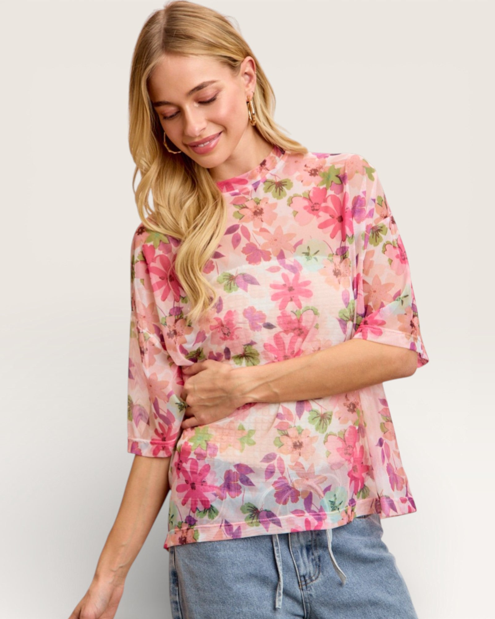 Woman wearing a floral blouse with a plain background