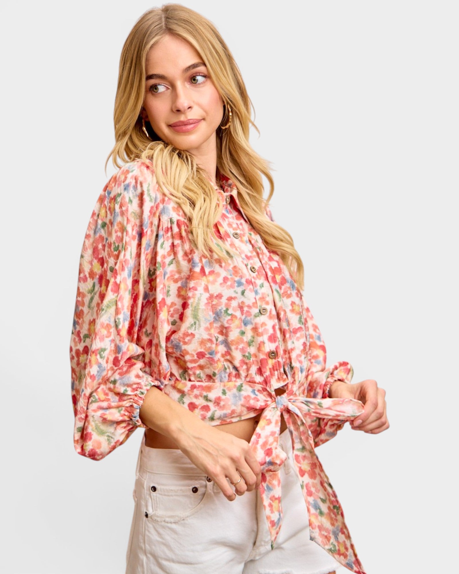 Woman wearing a floral blouse with a plain background