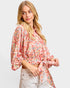 Woman wearing a floral blouse with a plain background