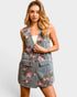 Woman wearing a floral denim vest over a white top on a light gray background
