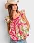 Woman wearing a floral top and cowboy hat against a plain background