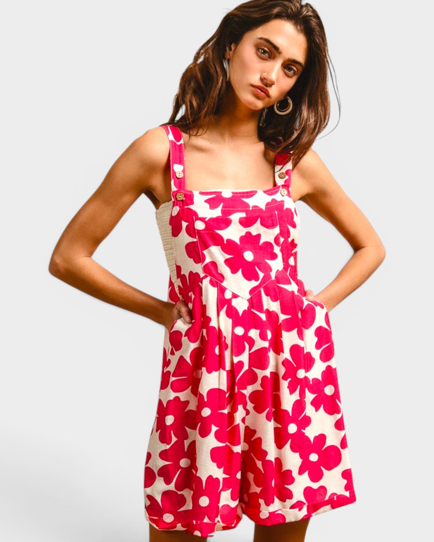 Woman wearing a pink floral dress on a white background