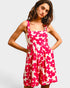 Woman wearing a pink floral dress on a white background