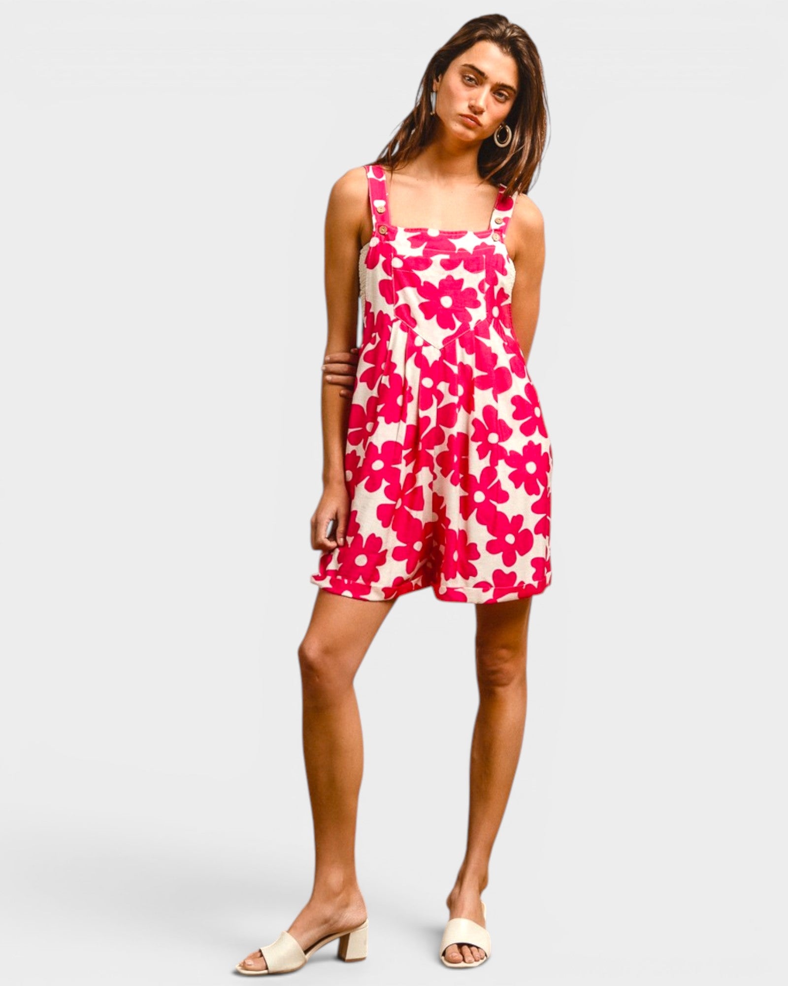 Woman wearing a pink floral dress on a white background
