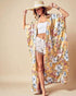 Woman wearing a floral kimono and straw hat on a beige background