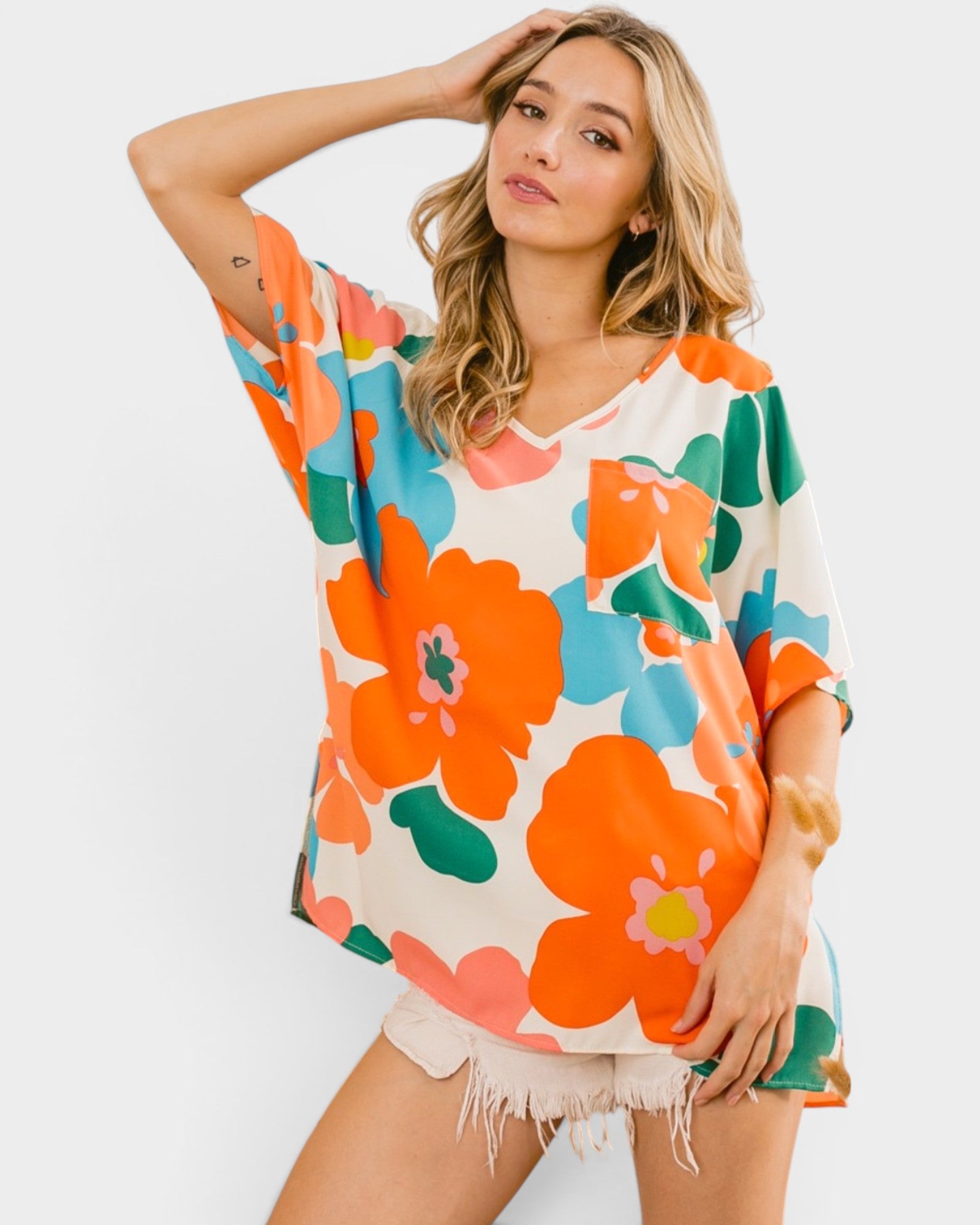 Woman wearing a colorful floral dress against a white background