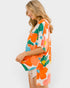Woman wearing a colorful floral kimono against a white background