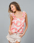 Woman wearing a pink floral tank top against a gray background