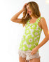 Woman wearing a green floral tank top against a white background