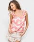 Woman wearing a pink floral tank top against a white background