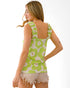 Woman wearing a green floral tank top on a white background