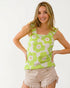Woman wearing a green floral sleeveless top on a white background