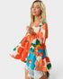 Woman wearing a colorful floral dress on a white background