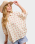 Woman wearing a floral blouse and cowboy hat on a white background