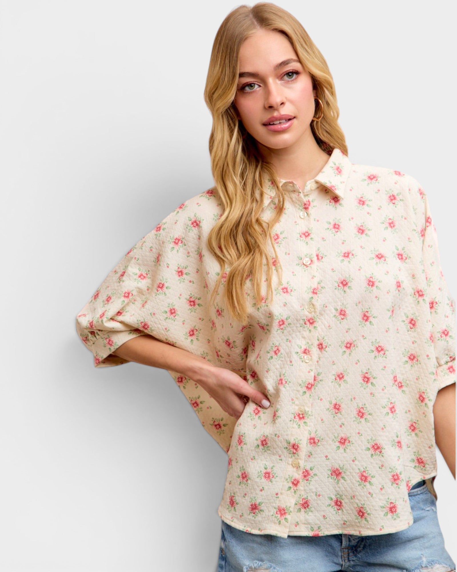 Woman wearing a floral blouse with a plain background