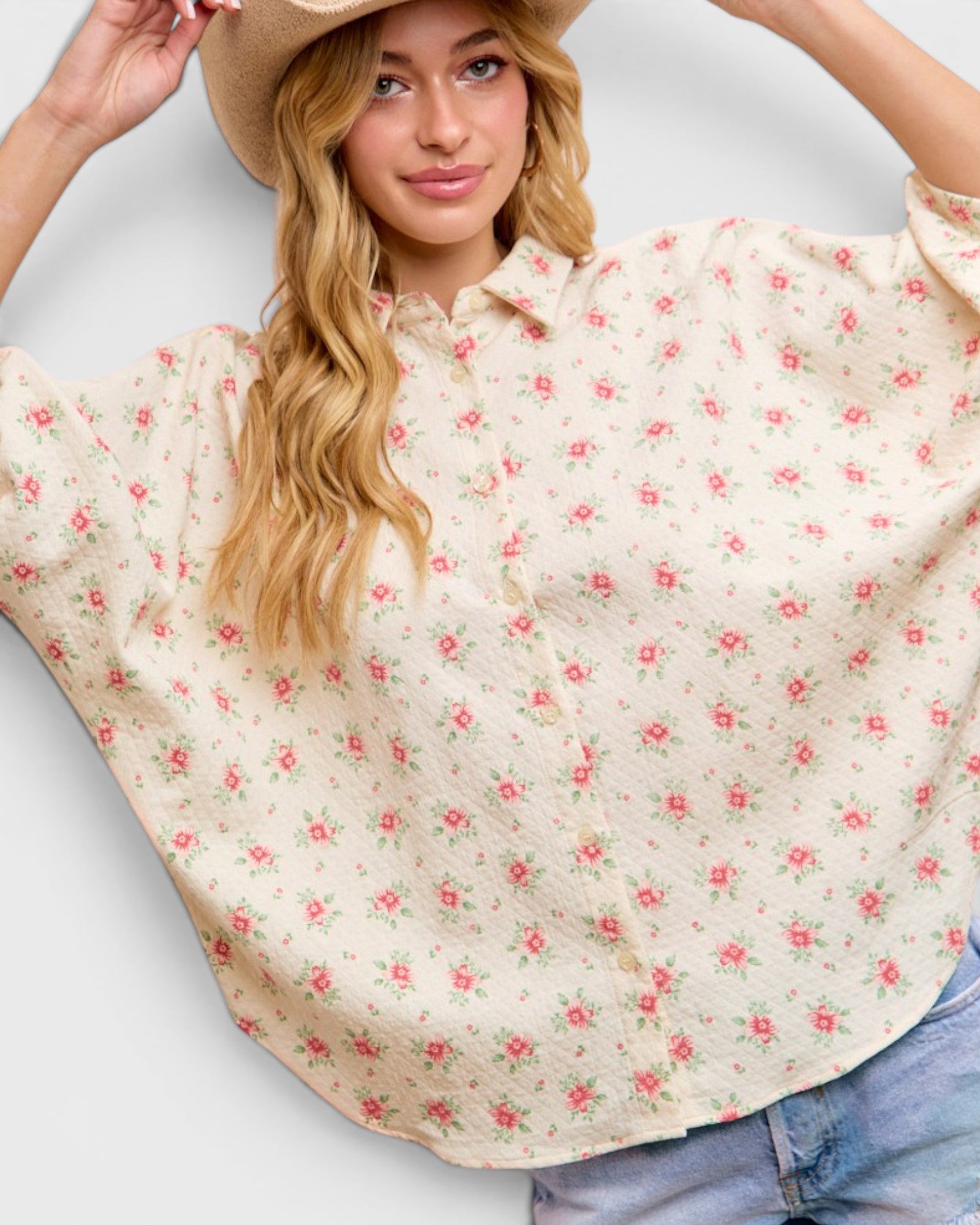 Woman wearing a floral blouse with a plain background