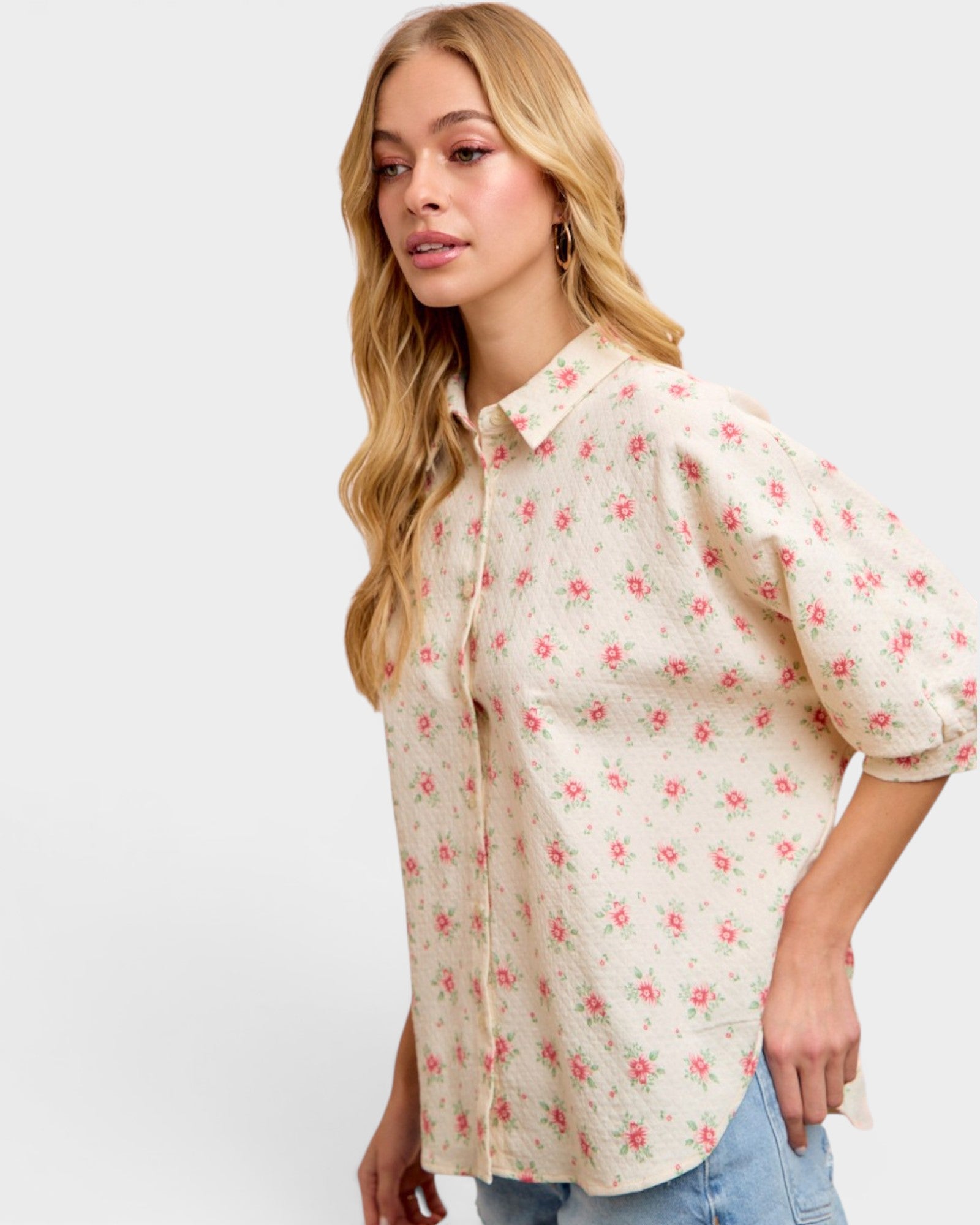 Woman wearing a floral blouse with a plain background