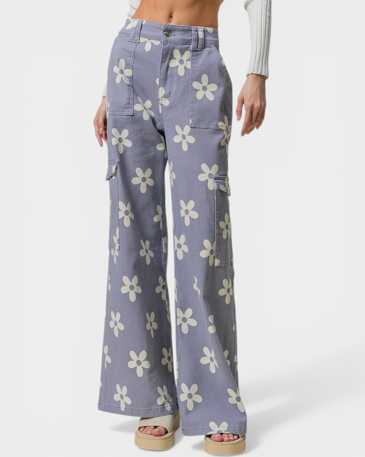 Floral-patterned pants worn by a person on a white background