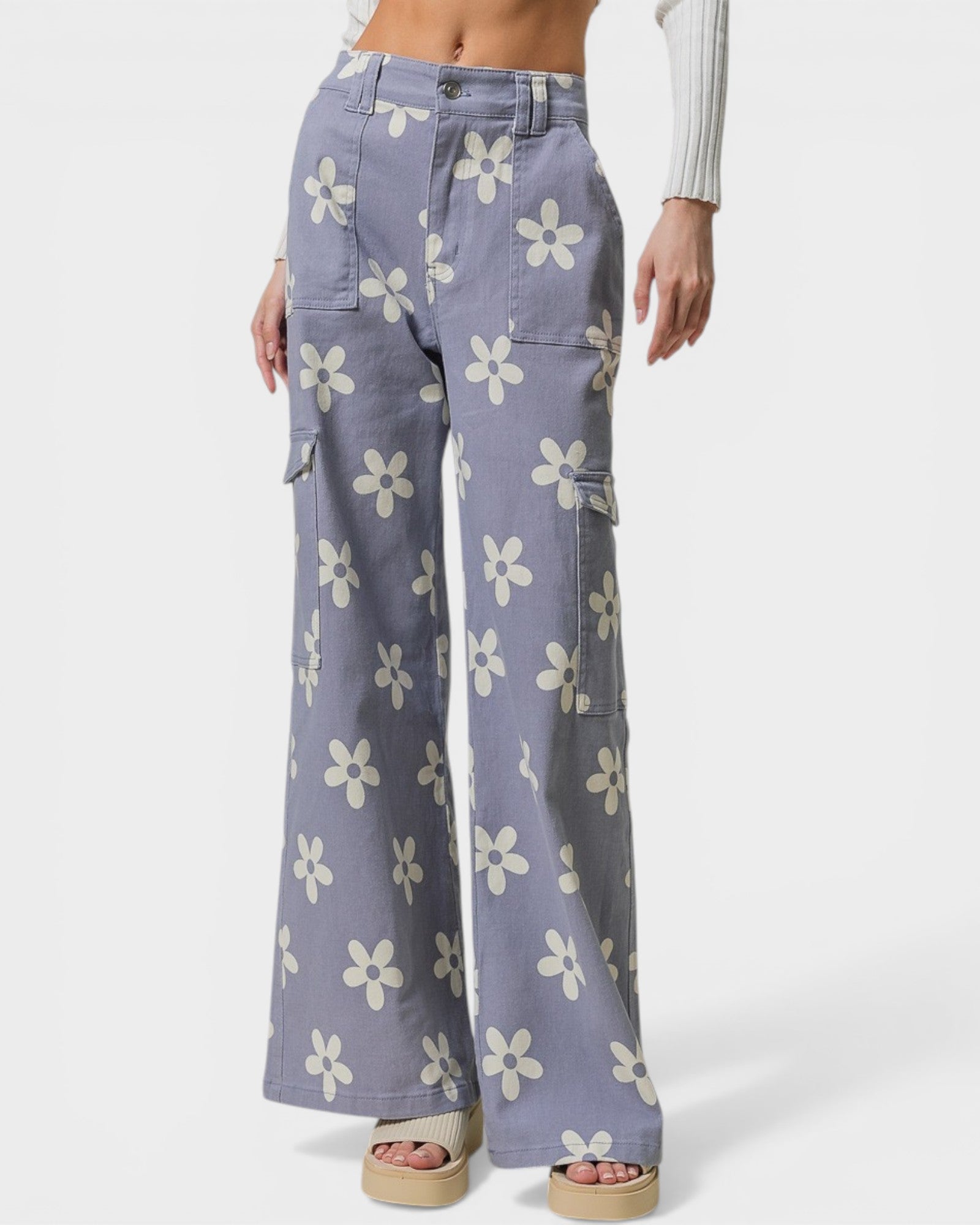 Floral-patterned pants worn by a person on a white background