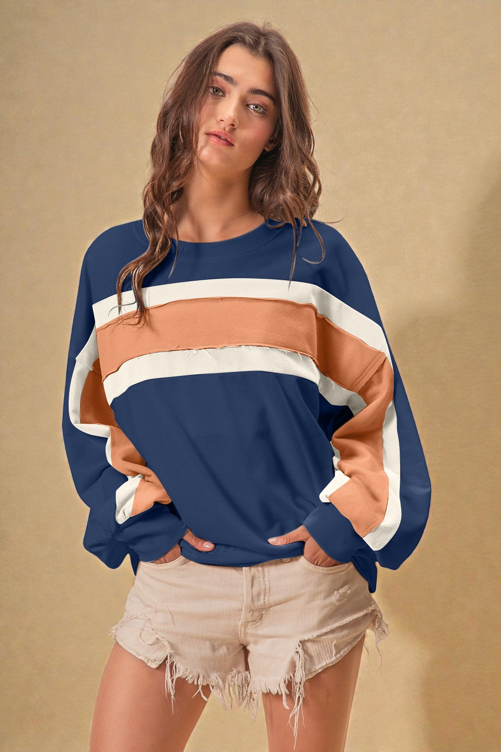 Woman wearing a colorful sweater with a beige background