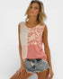 Woman wearing a sleeveless top with pink and beige leopard print pattern on a white background