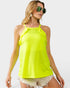 Woman wearing a bright yellow tank top and sunglasses on a white background