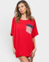 Woman wearing a red oversized t-shirt with an American flag design on a white background