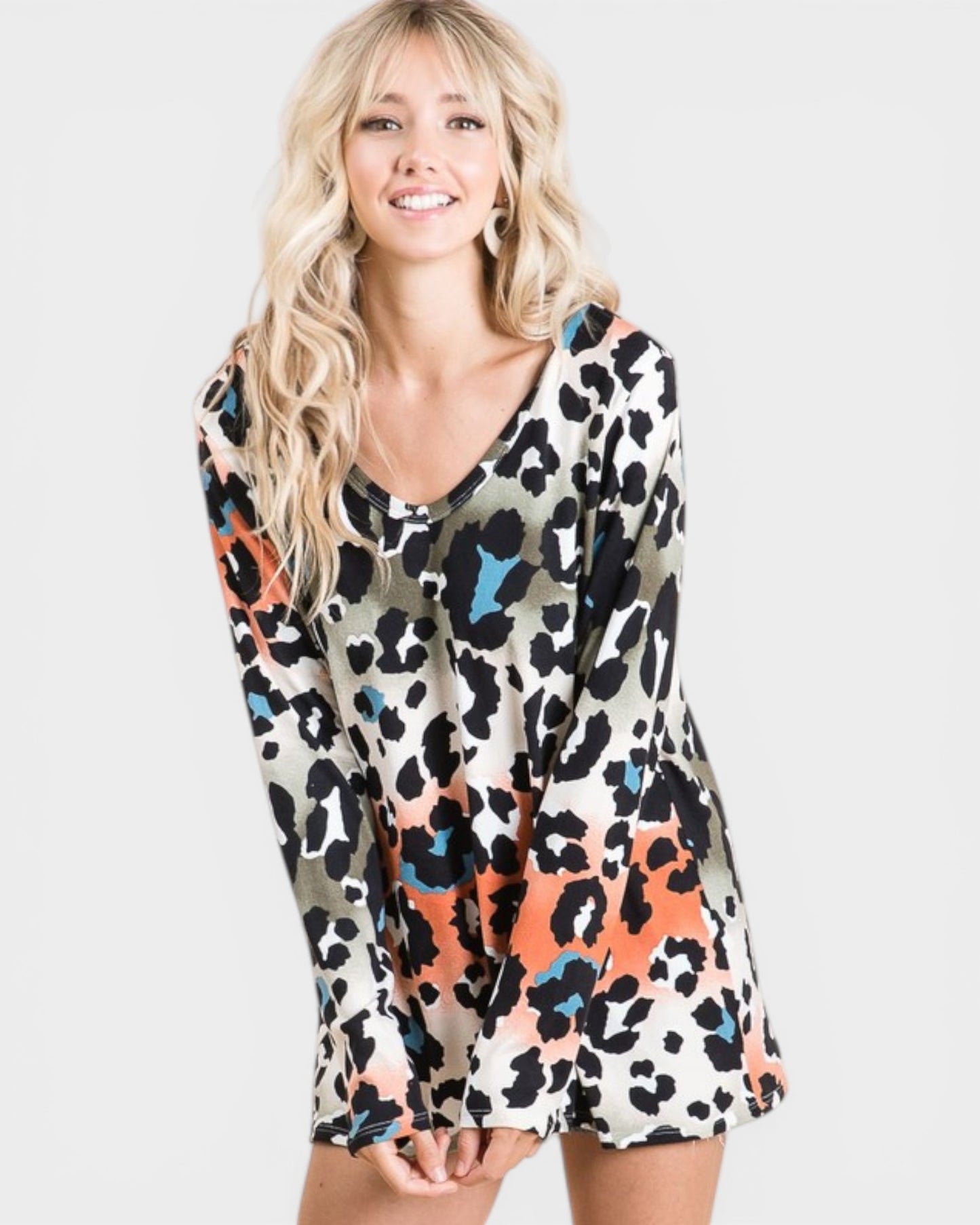 Woman wearing a colorful leopard print dress on a white background