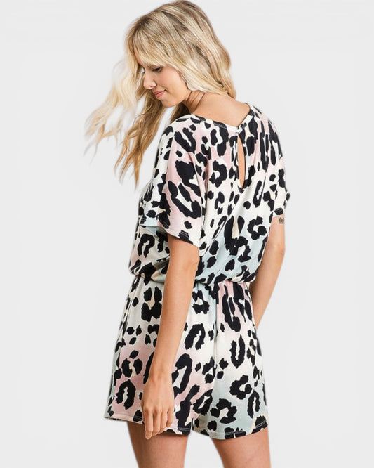 Woman wearing a leopard print romper on a white background