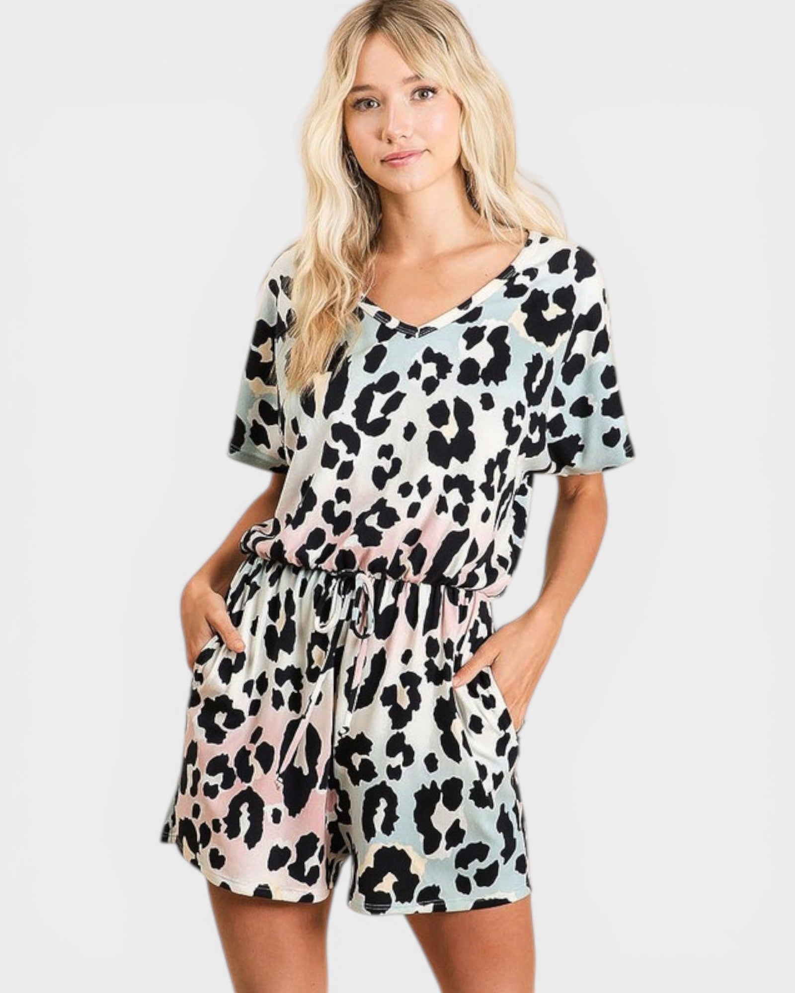 Woman wearing a leopard print romper on a white background