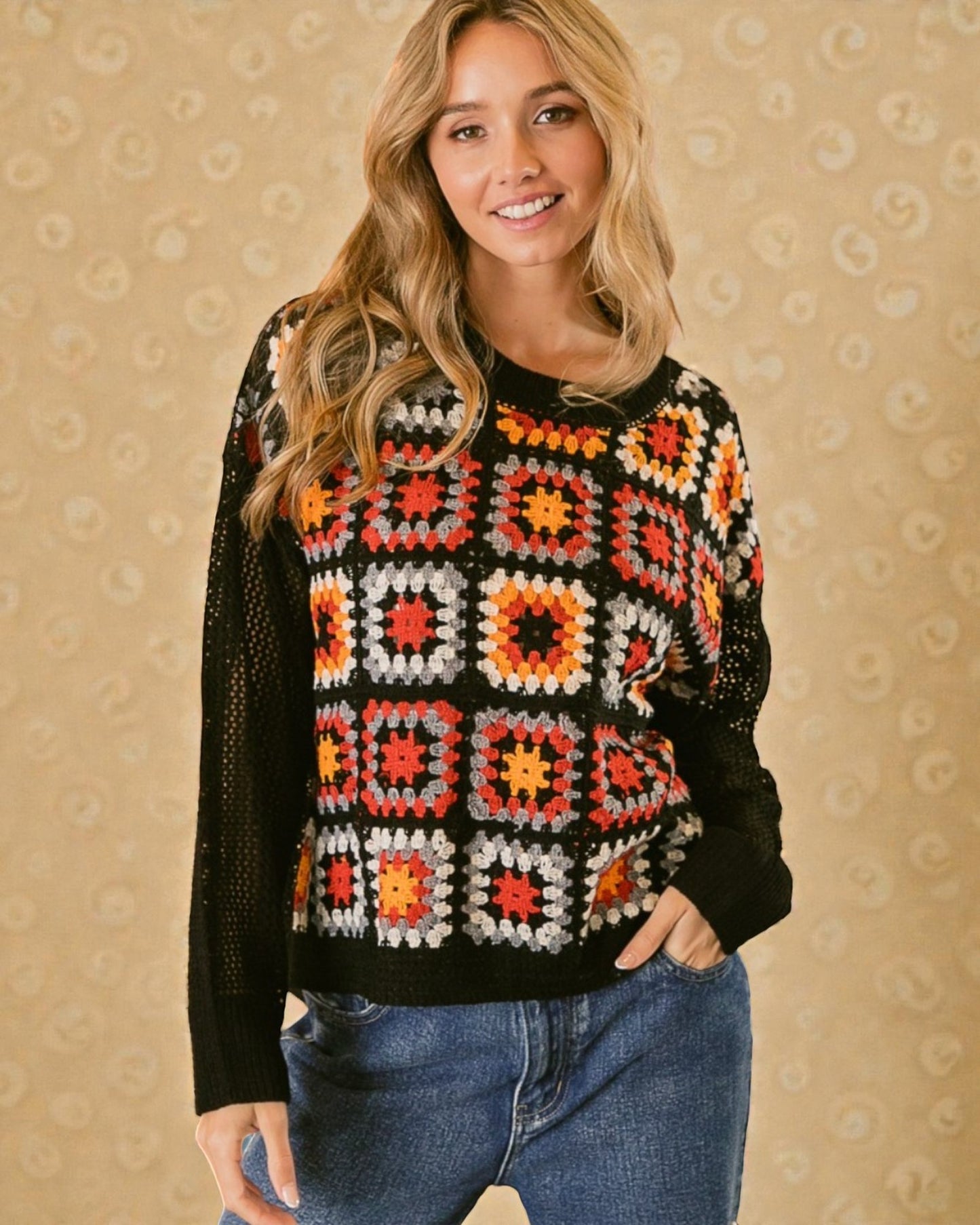Woman wearing a colorful patterned sweater against a beige background