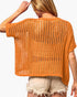 A woman shown from the back wearing a loose, short-sleeve crochet knit top in a warm orange-brown color, paired with light beige frayed denim shorts against a plain white background.