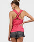 Woman wearing a pink tank top with a unique back design on a white background