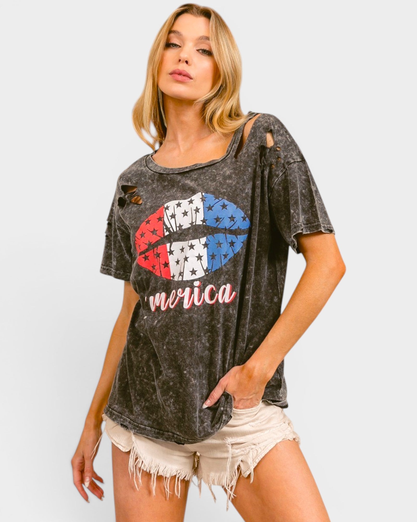 Woman wearing a graphic t-shirt with a colorful design and 'merica' text on a plain background
