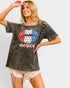 Woman wearing a graphic t-shirt with a design on a plain background