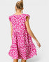 Woman wearing a pink leopard print dress on a white background