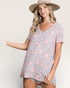 Woman wearing a patterned dress with a neutral background
